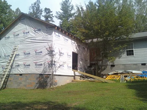 Tyvek wrapped gable on a new room addition beside an existing home in Lyndonville