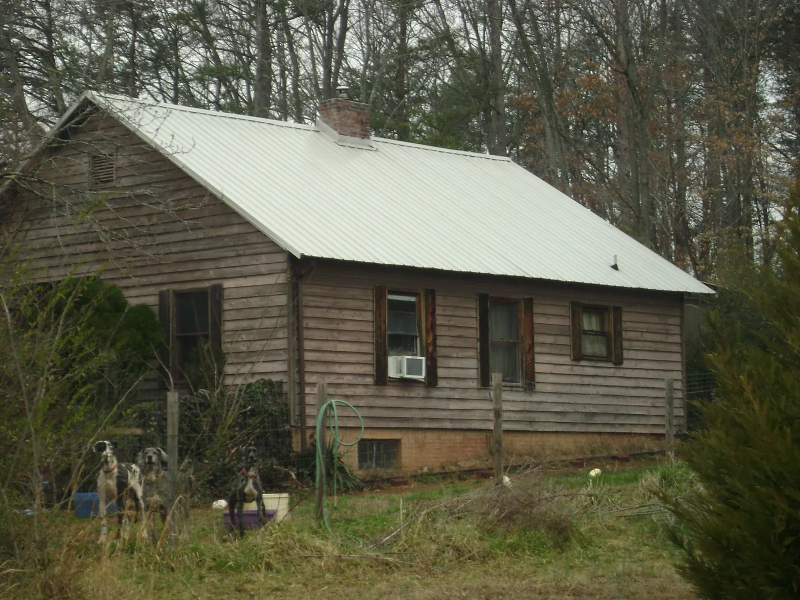 White metal roof on an old wood sided farmhouse, from a Metal Roof Installation job in Lyndonville